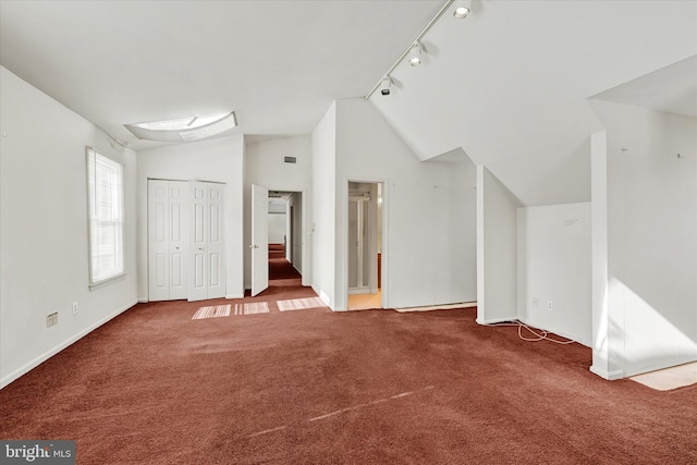 interior space with vaulted ceiling and carpet