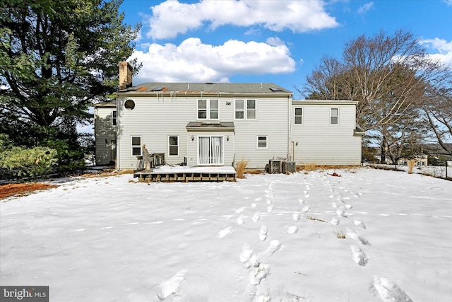 snow covered house with a deck