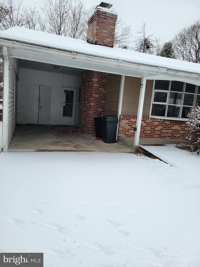 exterior space featuring an attached carport and driveway