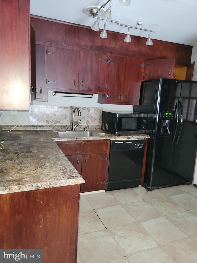 kitchen with a sink, tasteful backsplash, and black appliances