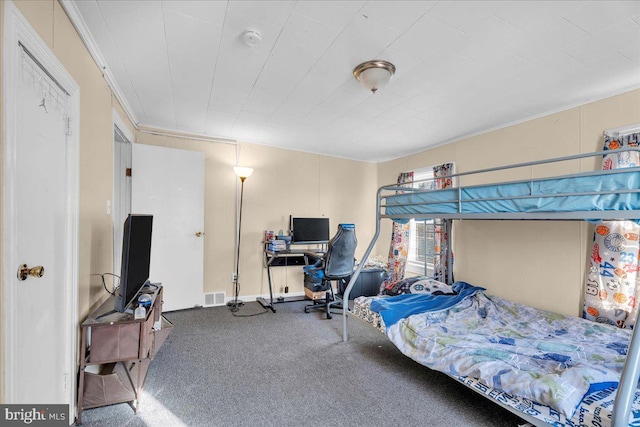 carpeted bedroom featuring crown molding