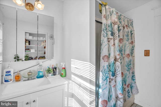 bathroom featuring walk in shower and vanity