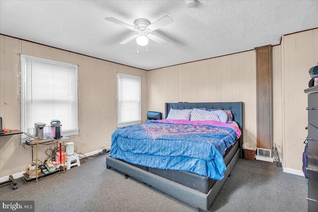 bedroom featuring ceiling fan, multiple windows, and a textured ceiling