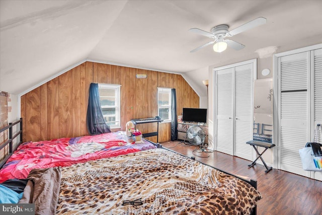 bedroom featuring vaulted ceiling, two closets, ceiling fan, and wood-type flooring