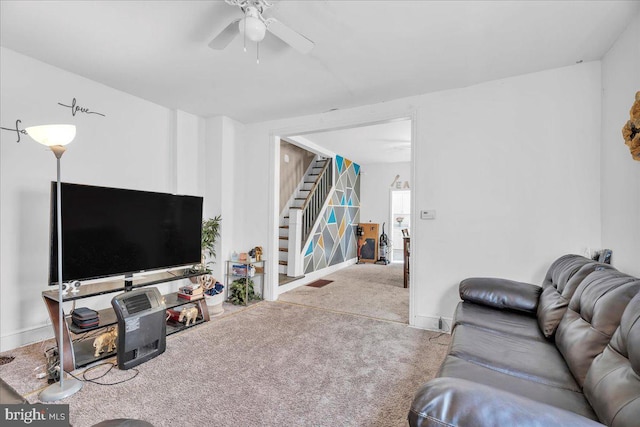 carpeted living room with ceiling fan