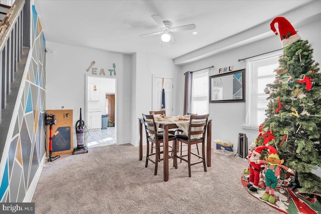 dining room with light carpet and ceiling fan