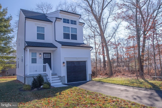 view of front of house featuring a garage and a front lawn