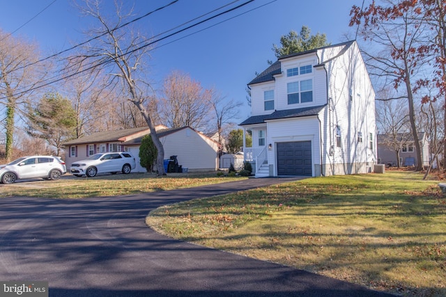 view of side of home featuring a yard and a garage