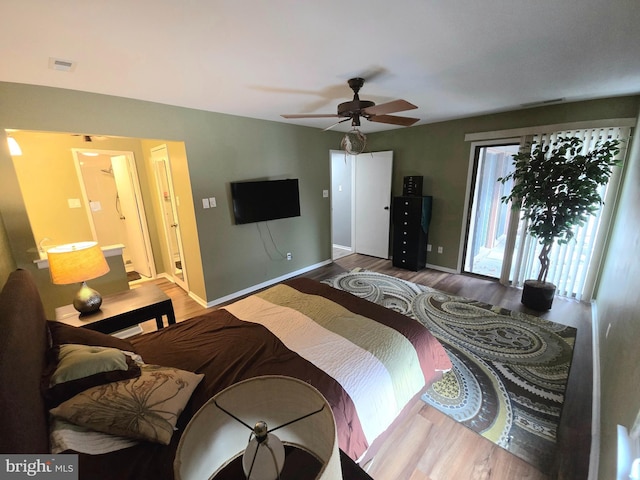 bedroom featuring access to exterior, ensuite bathroom, ceiling fan, and hardwood / wood-style flooring