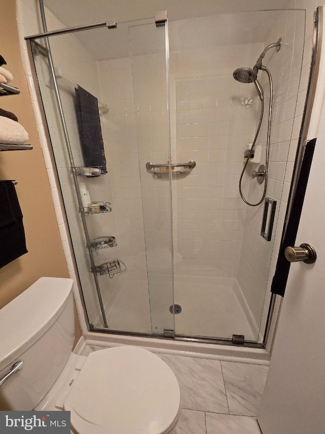 bathroom with toilet and walk in shower