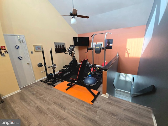 exercise area with ceiling fan, hardwood / wood-style floors, and lofted ceiling