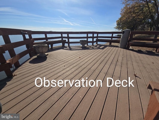 wooden deck with a water view