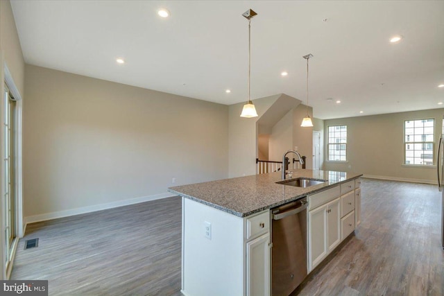 kitchen featuring sink, white cabinetry, a center island with sink, decorative light fixtures, and stainless steel dishwasher