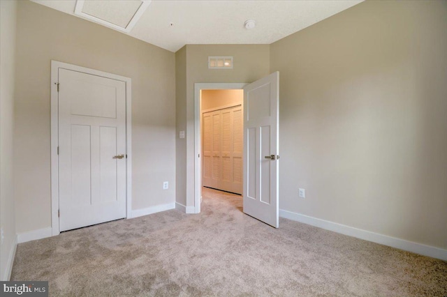 unfurnished bedroom featuring light carpet