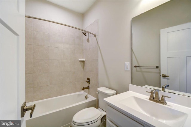 full bathroom featuring vanity, toilet, and tiled shower / bath