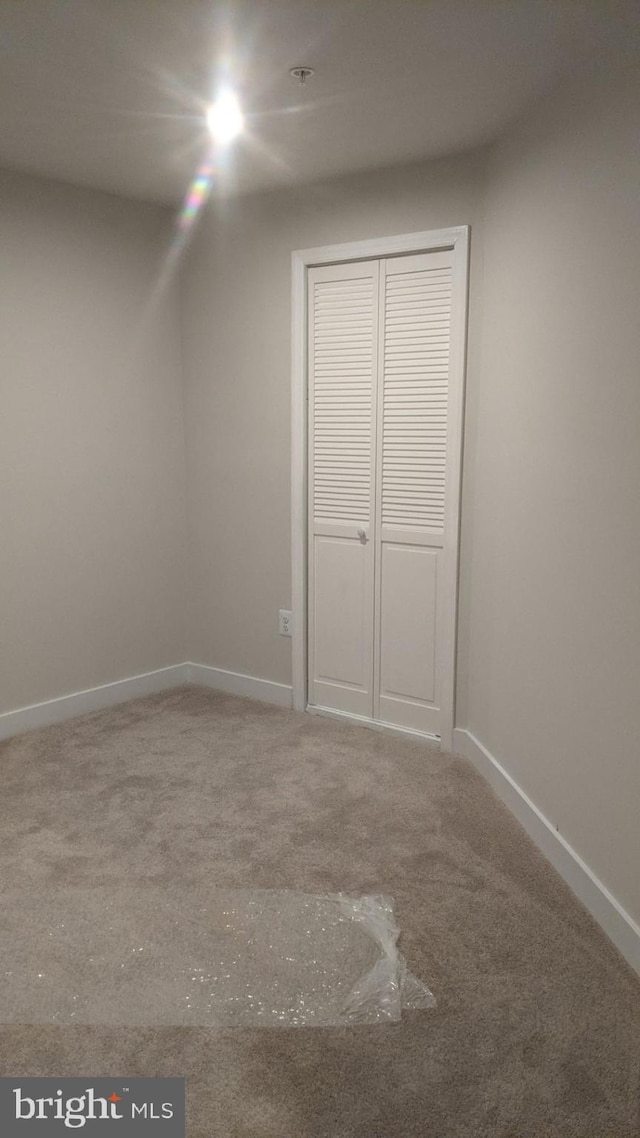 unfurnished bedroom with a closet and carpet