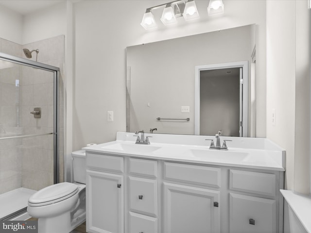 bathroom featuring vanity, toilet, and an enclosed shower