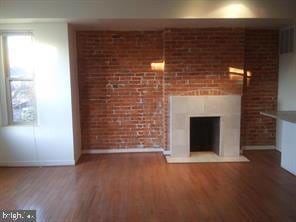 unfurnished living room featuring wood-type flooring