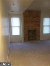 unfurnished living room with a fireplace