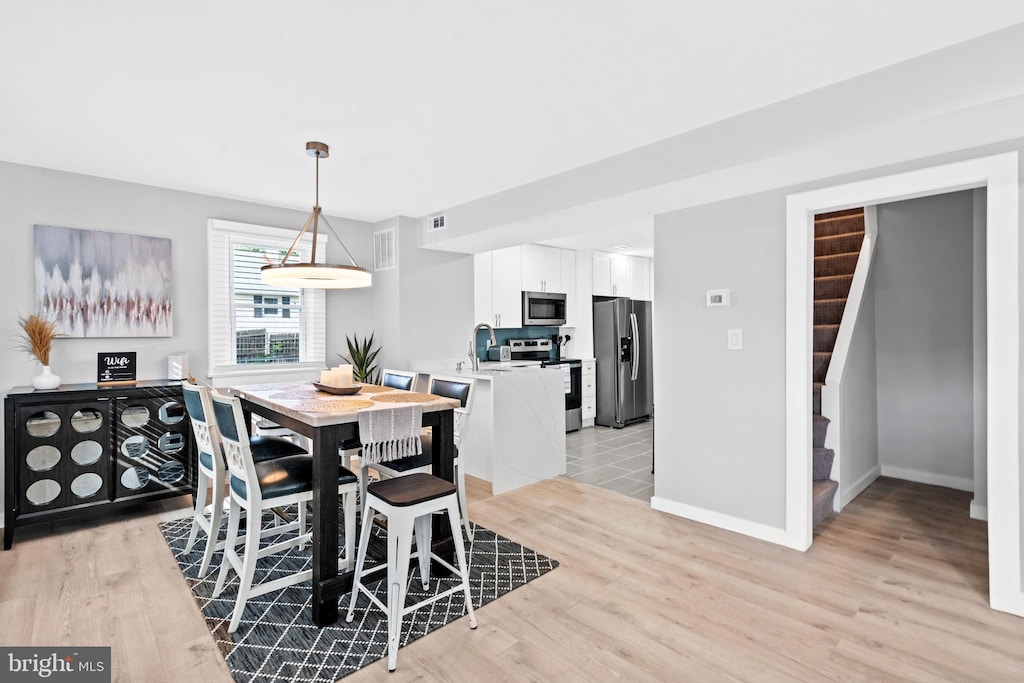 dining area with light hardwood / wood-style flooring