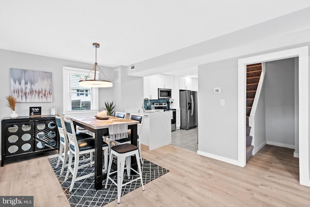 dining area with light hardwood / wood-style flooring