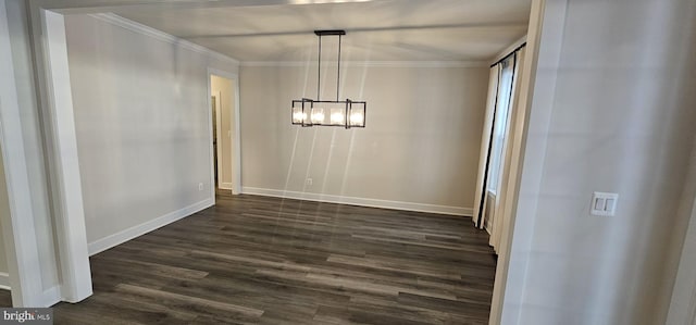 unfurnished dining area with ornamental molding, dark hardwood / wood-style floors, and an inviting chandelier