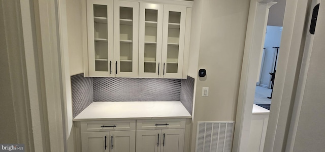 kitchen with white cabinetry and decorative backsplash