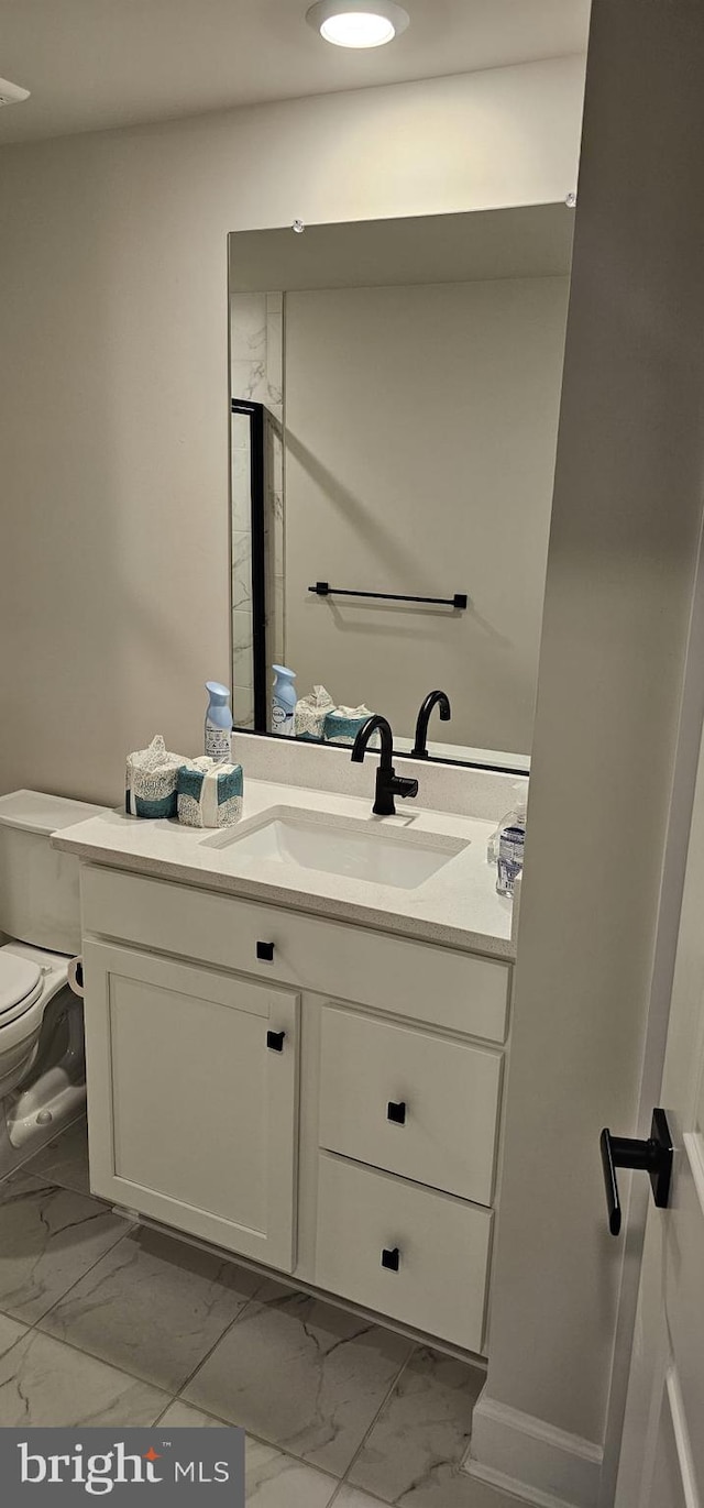 bathroom featuring vanity and toilet