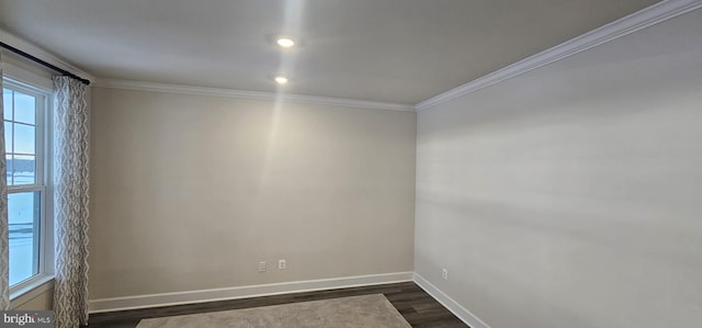 spare room featuring dark hardwood / wood-style flooring and crown molding