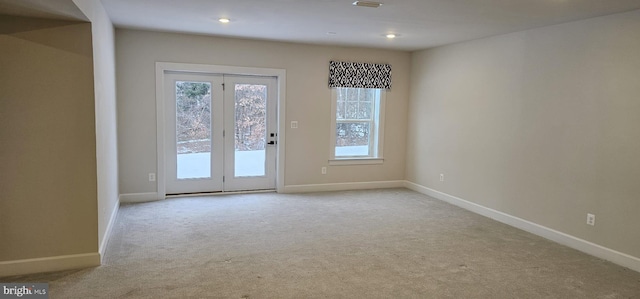 entryway featuring light carpet and a wealth of natural light