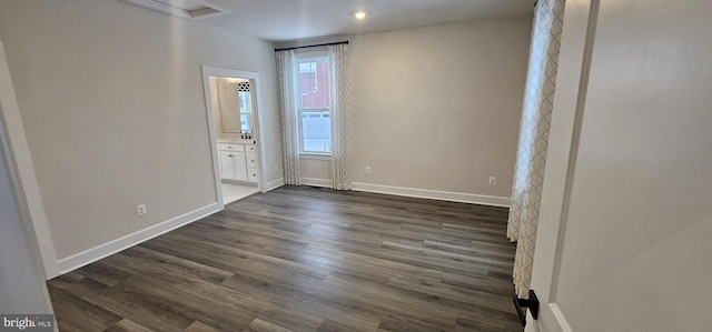 spare room with dark hardwood / wood-style floors