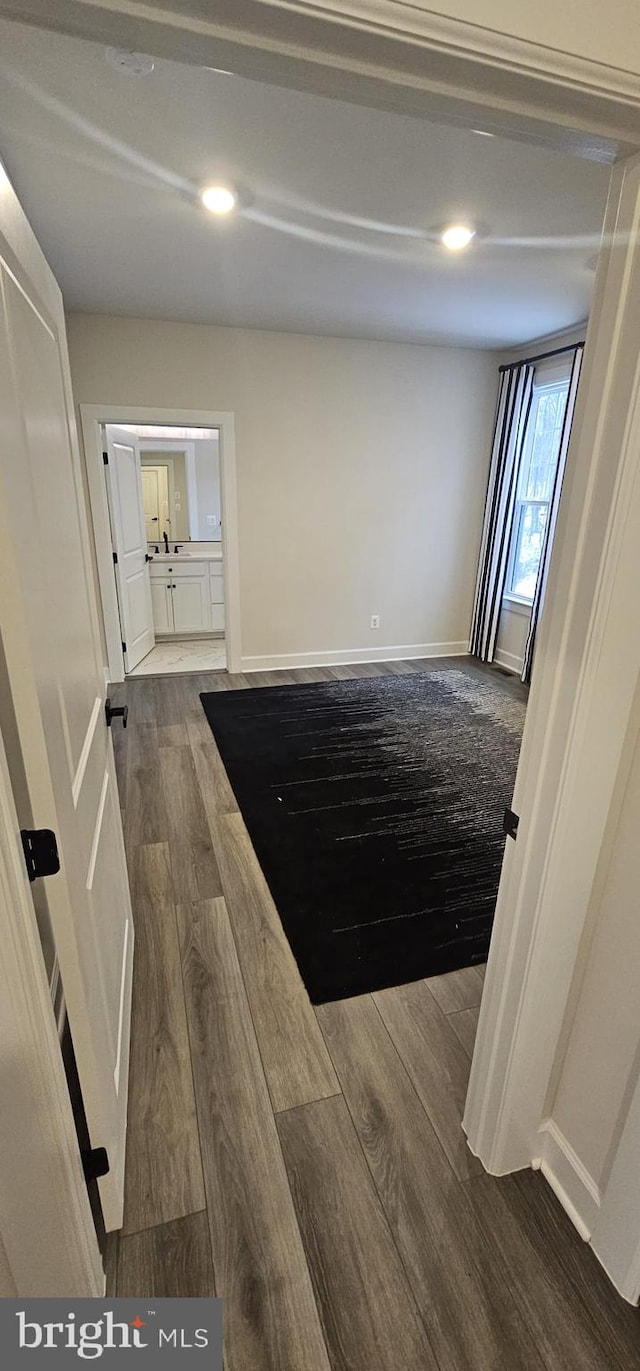 hallway with hardwood / wood-style flooring