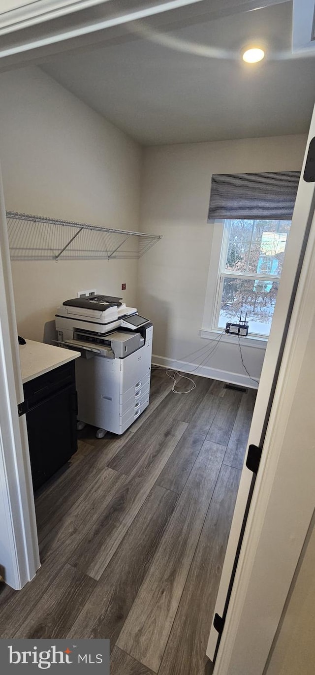 clothes washing area with dark hardwood / wood-style floors