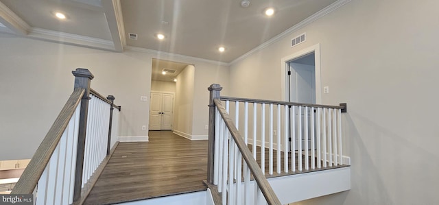 stairs with wood-type flooring and ornamental molding