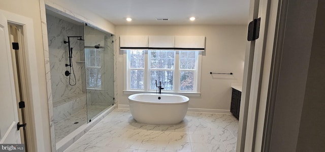 bathroom with vanity and shower with separate bathtub