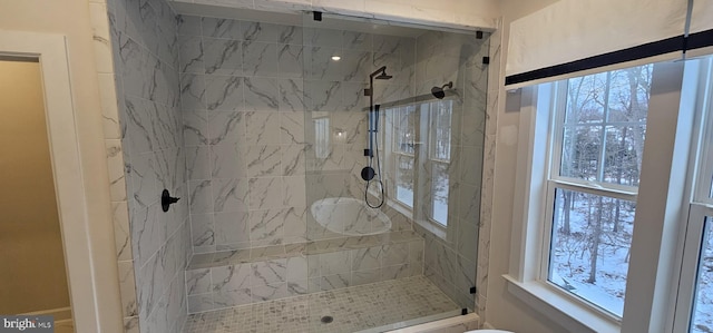 bathroom featuring walk in shower and a wealth of natural light