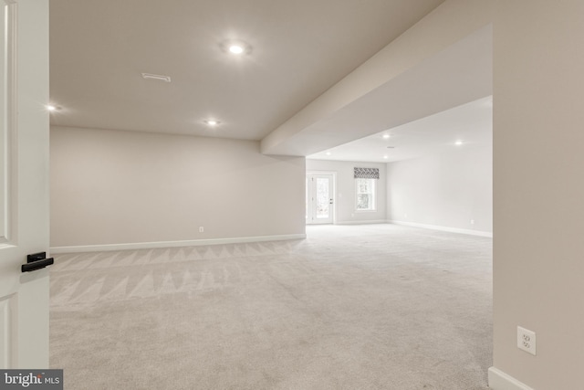 unfurnished room featuring light carpet