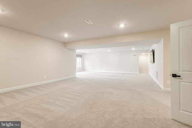 unfurnished room featuring light carpet