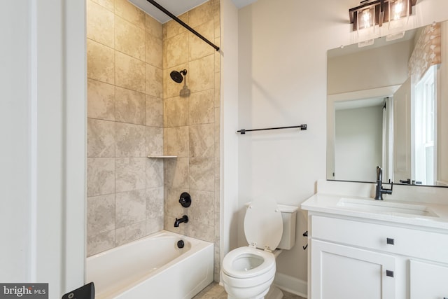 full bathroom with vanity, toilet, and tiled shower / bath combo