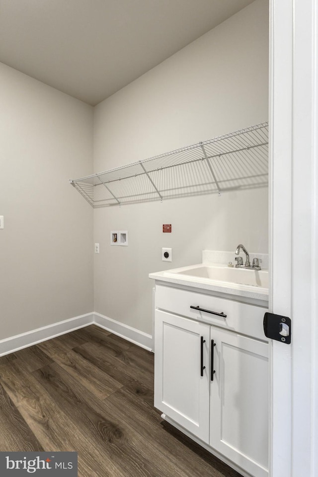 clothes washing area featuring electric dryer hookup, sink, hookup for a washing machine, and dark wood-type flooring