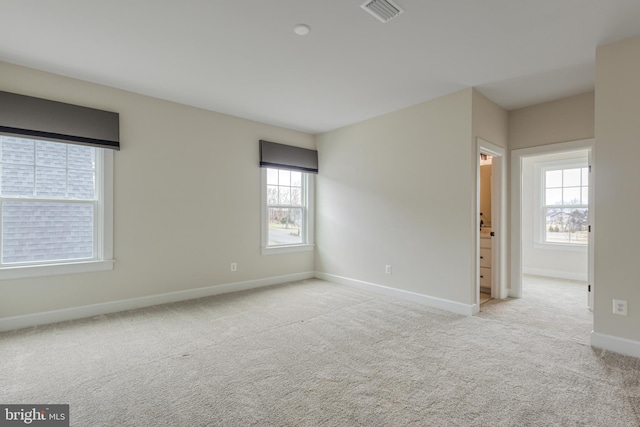 unfurnished room featuring light carpet