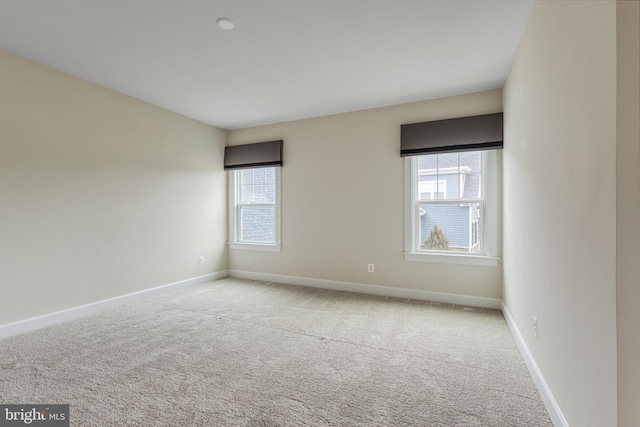 unfurnished room featuring light carpet