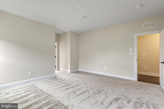 empty room featuring light colored carpet