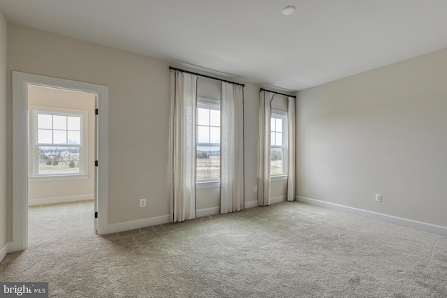 unfurnished room with light colored carpet