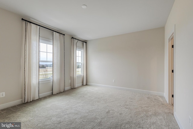 empty room featuring light carpet