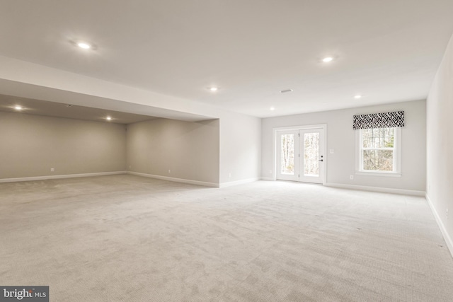 unfurnished living room featuring light colored carpet