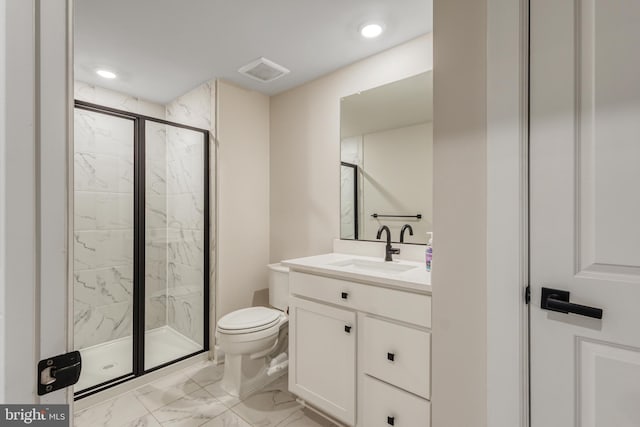 bathroom featuring a shower with door, vanity, and toilet