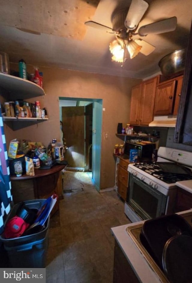 kitchen with white gas range and ceiling fan