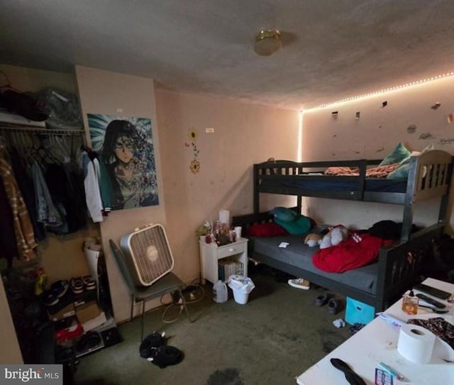 bedroom with a textured ceiling and carpet floors