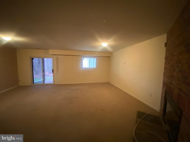 basement featuring a fireplace and carpet